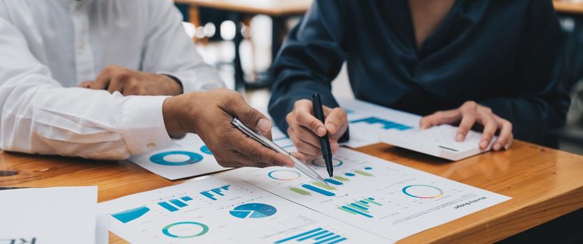 Business people meeting to analyse and discussing financial report chart data in office. Financial advisor teamwork and accounting concept