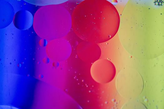 Oil drops in water. Abstract defocused psychedelic pattern image rainbow colored. Abstract background with colorful gradient colors. DOF