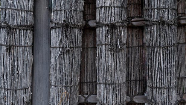 Decorative hedge of bunches of dry rods and tree branches. High quality photo