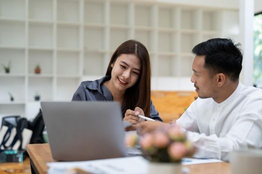 Asian business adviser meeting to analyze and discuss the situation on the financial report in the meeting room.Investment Consultant, Financial advisor and accounting concept.