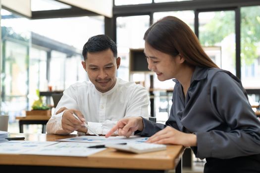 Asian business adviser meeting to analyze and discuss the situation on the financial report in the meeting room.Investment Consultant, Financial advisor and accounting concept.