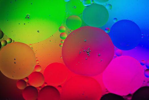 Oil drops in water. Abstract psychedelic pattern image rainbow colored. Abstract background with colorful gradient colors. DOF