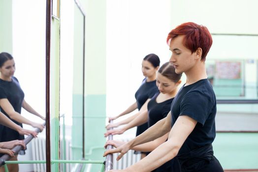 Warming, training, dancing in a big ballet studio
