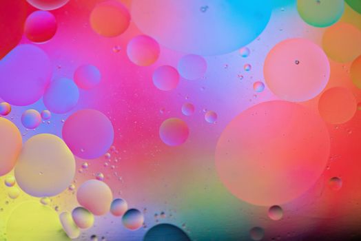 Oil drops in water. Abstract psychedelic pattern image rainbow colored. Abstract background with colorful gradient colors. DOF