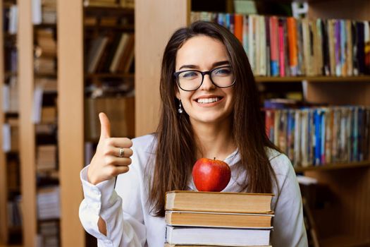 Brunette female student ready for learning in the library