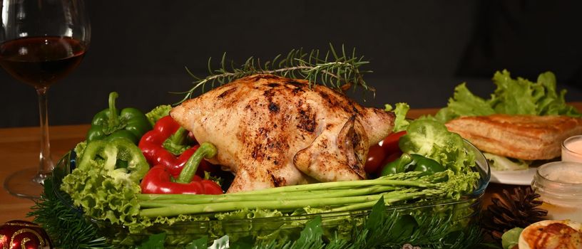 Traditional roasted turkey and side dishes on wooden table for holiday dinner. Thanksgiving celebration traditional dinner concept.