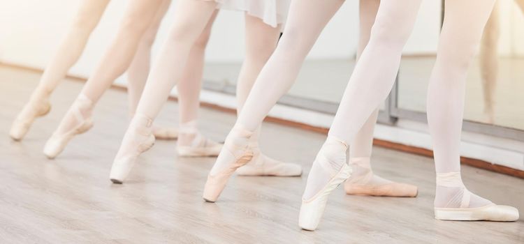 Fitness, art and ballet dance class training practice creative dancing in a studio or center, wellness movement lesson. Closeup on shoes of women dancers learning a routine, prepare for performance.