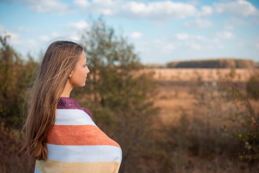 Beautiful girl admiring warm autumn weather, having a walk on nature