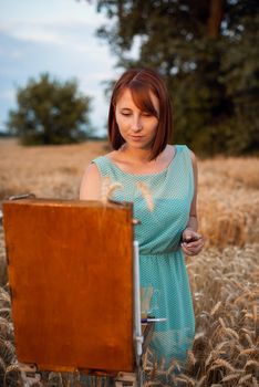 Last warm rays of setting sun kisses face of a concentrated artist during work