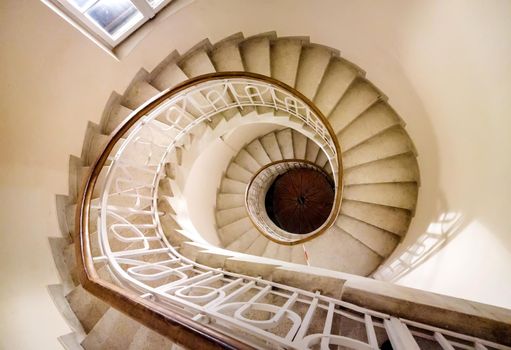Top view of the spiral staircase in the tower. Walking down old the winding stairs
