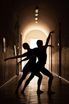 Performing a dance in a corridor with high ceiling