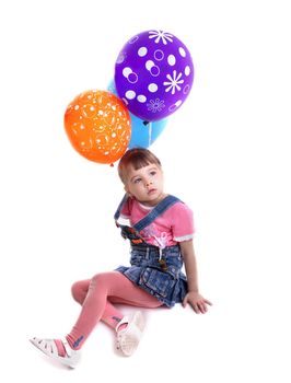 Little girl with colored balloons. Isolated on white