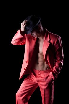 Sexy man in red suit Dancer on black background