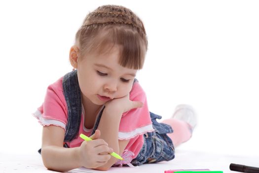 Little girl drawing on floor. Isolated on white