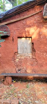 old clay house made of thatch, in Brazil with earthy colors