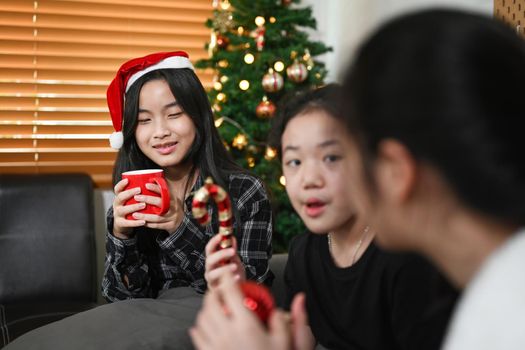 Asian girl celebrating Christmas with her friends at home.