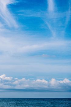 Atmosphere VERTICAL panorama real photo beauty nature wallpaper. Fantastic sky view clouds cumulus cirrus stratus sea horizon line. Wallpaper design background like painted fairy tale mood.