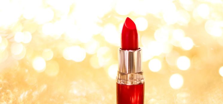 Cosmetic branding, sale and glamour concept - Red lipstick on golden Christmas, New Years and Valentines Day holiday glitter background, make-up and cosmetics product for luxury beauty brand