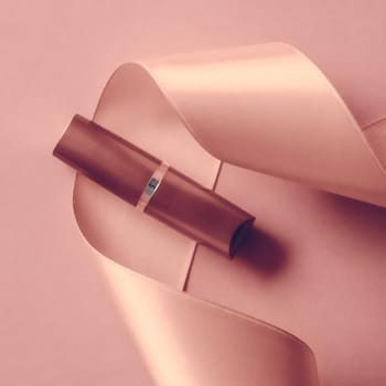Cosmetic branding, glamour lip gloss and shopping sale concept - Luxury lipstick and silk ribbon on blush pink holiday background, make-up and cosmetics flatlay for beauty brand product design