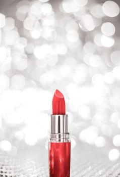 Cosmetic branding, sale and glamour concept - Coral lipstick on silver Christmas, New Years and Valentines Day holiday glitter background, make-up and cosmetics product for luxury beauty brand