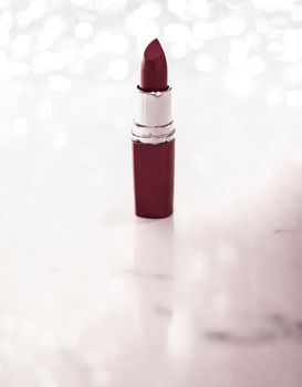 Cosmetic branding, sale and glamour concept - Chocolate lipstick on silver Christmas, New Years and Valentines Day holiday glitter background, make-up and cosmetics product for luxury beauty brand