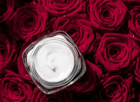 Luxe cosmetics, branding and anti-age concept - Face cream skin moisturizer and red roses flowers, luxury skincare cosmetic product on floral background as beauty brand holiday flatlay design