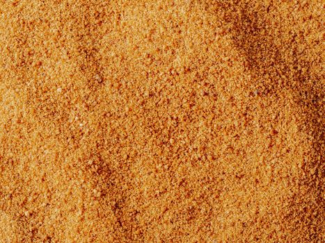 Background texture of raw organic coconut sugar from crystallized sap of cut flower buds coconut palm. Brown coconut palm sugar background topview. Alternative healthier low glycemic index sweetener