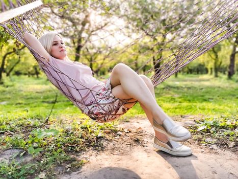 attractive woman 30 years old in a hammock. Outdoor.