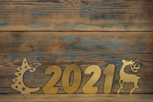 2021 happy new year gold number on wood table with space for text. 