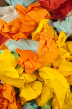 Heap crumpled colorful paper background. Close-up.