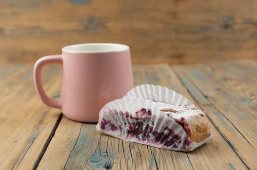 Homemade berry pie. Delicious Strudel with a cherry. Pie, strudel with berries and cup of hot tea on rustic wooden table background. Sweet healthy vegetarian dessert food. 