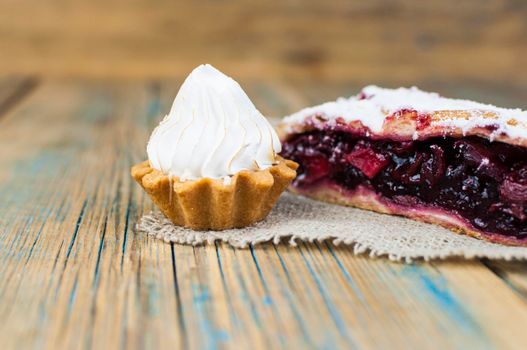 Homemade berry pie. Delicious Strudel with a cherry. Pie, strudel with berries on rustic wooden table background. Sweet healthy vegetarian dessert food. 