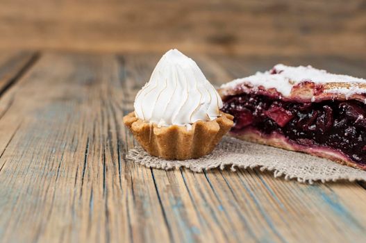 Homemade berry pie. Delicious Strudel with a cherry. Pie, strudel with berries on rustic wooden table background. Sweet healthy vegetarian dessert food. 