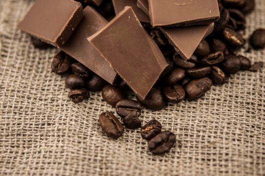 Chocolate and coffee beans on a textile background