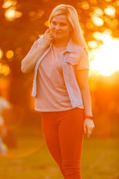 Young woman on field over sunset.