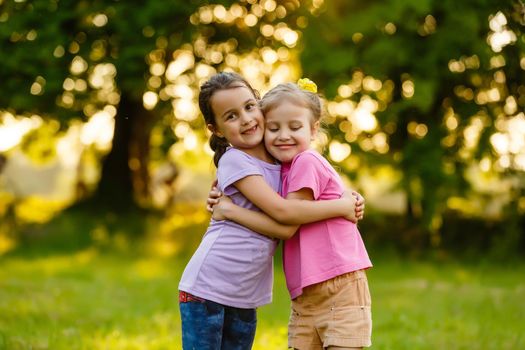 two little girls walking in the field