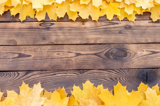 Autumn leaves frame on one down and up side wooden background top view Fall Border yellow and Orange Leaves vintage wood table Copy space. Mock up for your design. Display for product or text