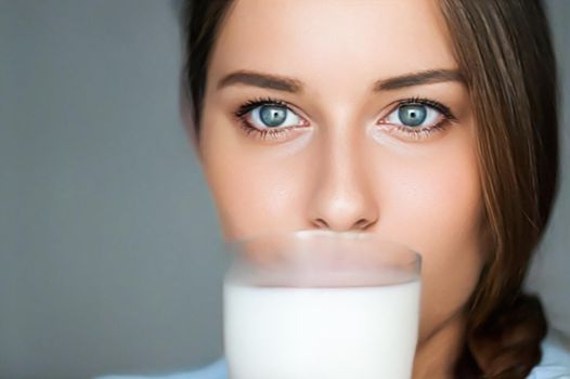 Diet and wellness, young woman with glass of milk or protein shake cocktail, portrait