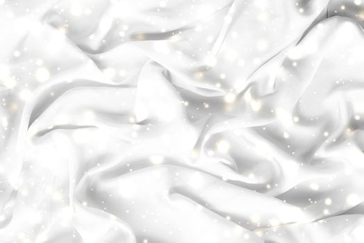 Winter fashion, shiny fabric and glamour style concept - Magic holiday white soft silk flatlay background texture with glowing snow, luxury beauty abstract backdrop