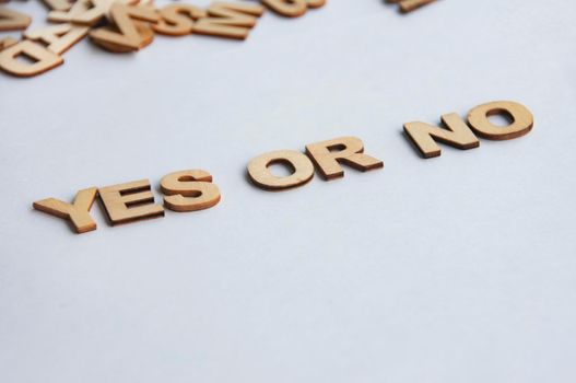 Yes or No wooden text on while cover background.