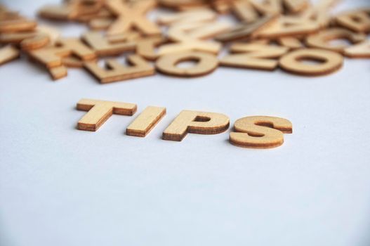 Tips wooden text on while cover background. Tips concept.