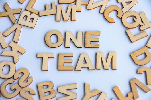 One team wooden text on while cover background. Teamwork concept.