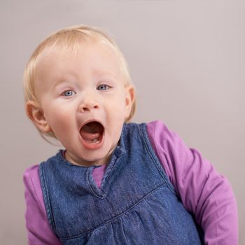 Hes such an adorable little boy. Studio shot of a baby girl making a face