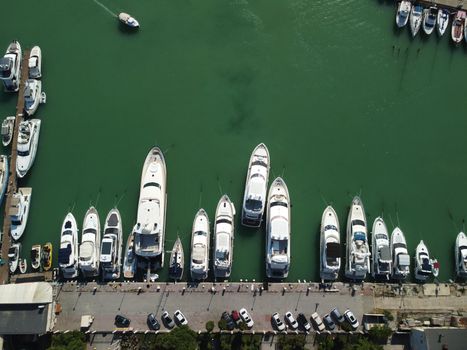 Aerial above Balaclava picturesque bay Crimea Sevastopol ancient resort city tourist attraction. Many yacht ships dock sail. Sea gulf of tectonic fault. Yachting on Black Sea coast film