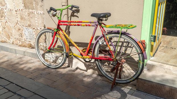 Colorful bicycle parked against the wall of the house. High quality photo