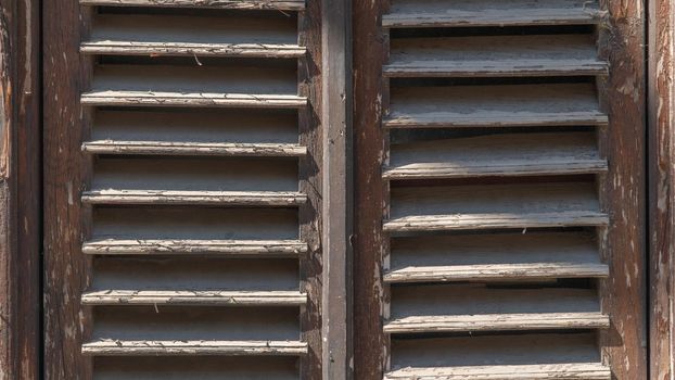 Old dilapidated wooden shutters it in the form of a lattice. High quality photo