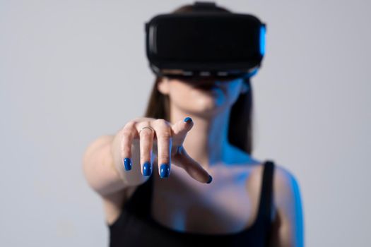 Technology, innovation gadgets. Brunette woman using virtual reality glasses.Virtual gadgets for entertainment, work, free time and study. Playing with VR