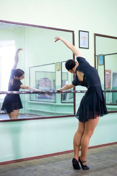 Ballerina making exercises in the mirror