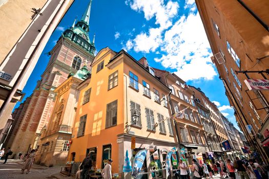 Stockholm, Sweden, August 26 2022: Busy tourist street of Stockholm old town. Shops and restaurants, and stunting architecture view.