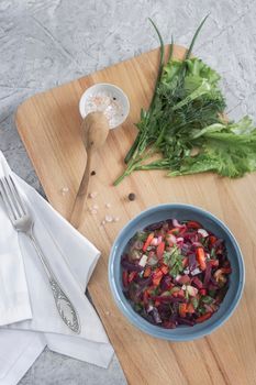 Vinaigrette with beetroot and boiled vegetables, traditional Russian homemade salad. Healthy food with vegetables for vegetarian dietary nutrition. View from above.